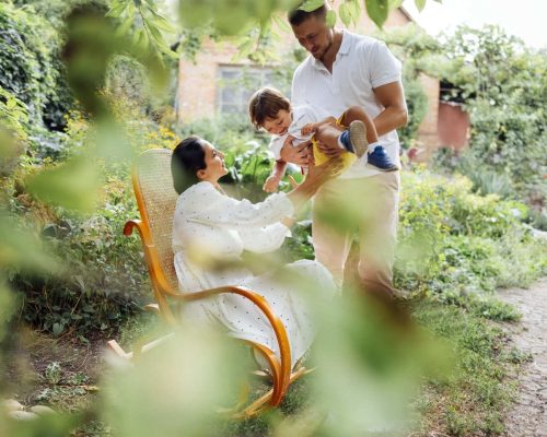 happy-family-playing-together-in-lush-green-garden-2026-03-17-06-40-41-utc